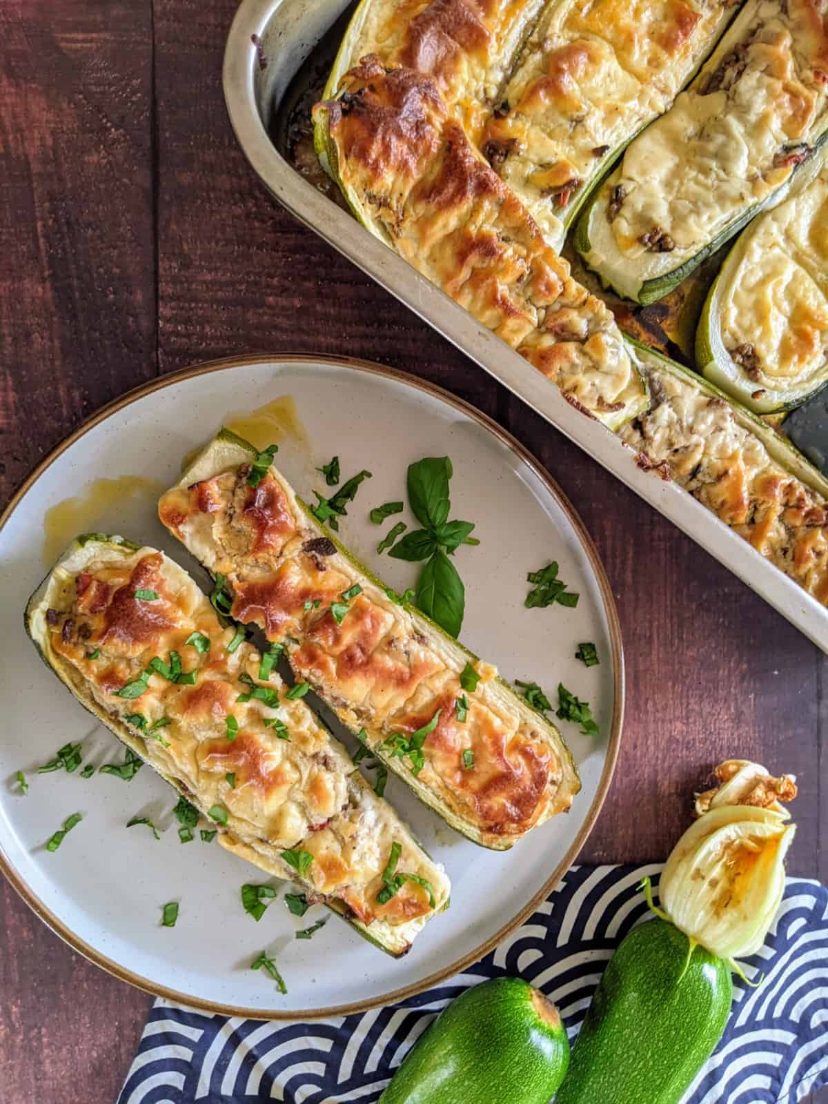 Served stuffed zucchini boats with a little bit of basil on top