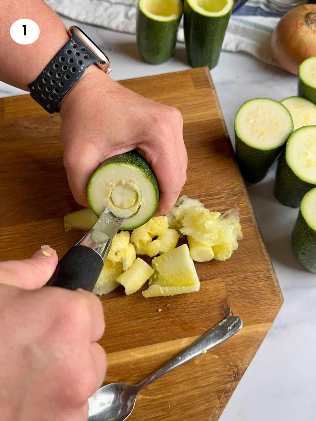 Removing the zucchini flesh with a corer.