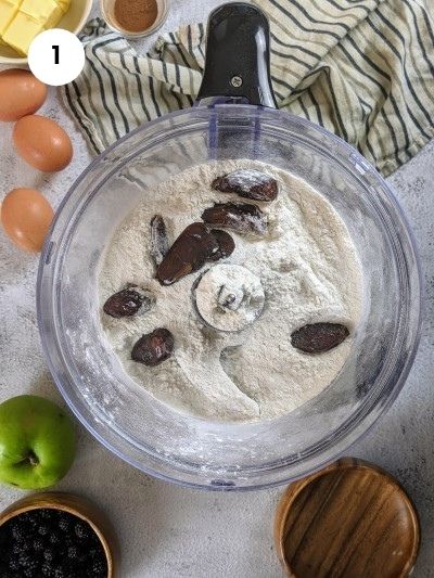 Adding the flour and dates to a food processor