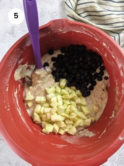 Adding the fruits to the mixture for the sugar free blackberry muffins