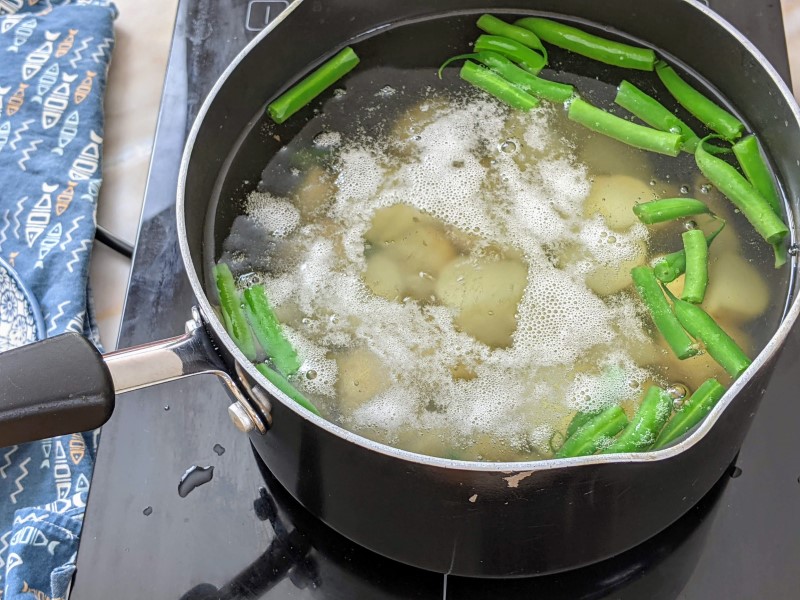 Boiling potatoes and beans.