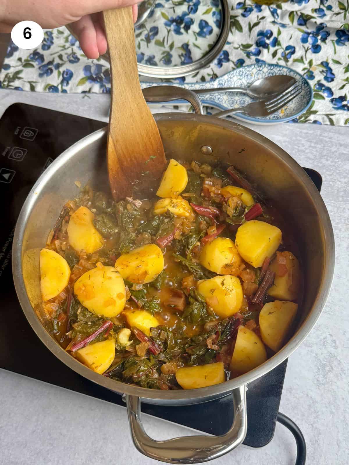 Cooked swiss chard with potatoes on the stove.