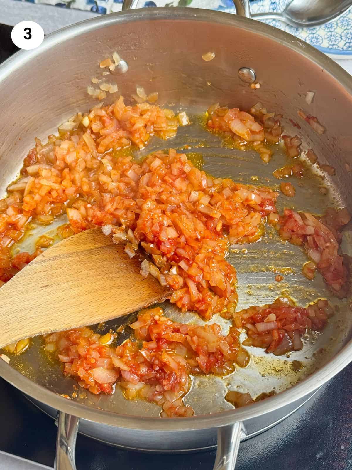 Cooking the onion and tomato paste.