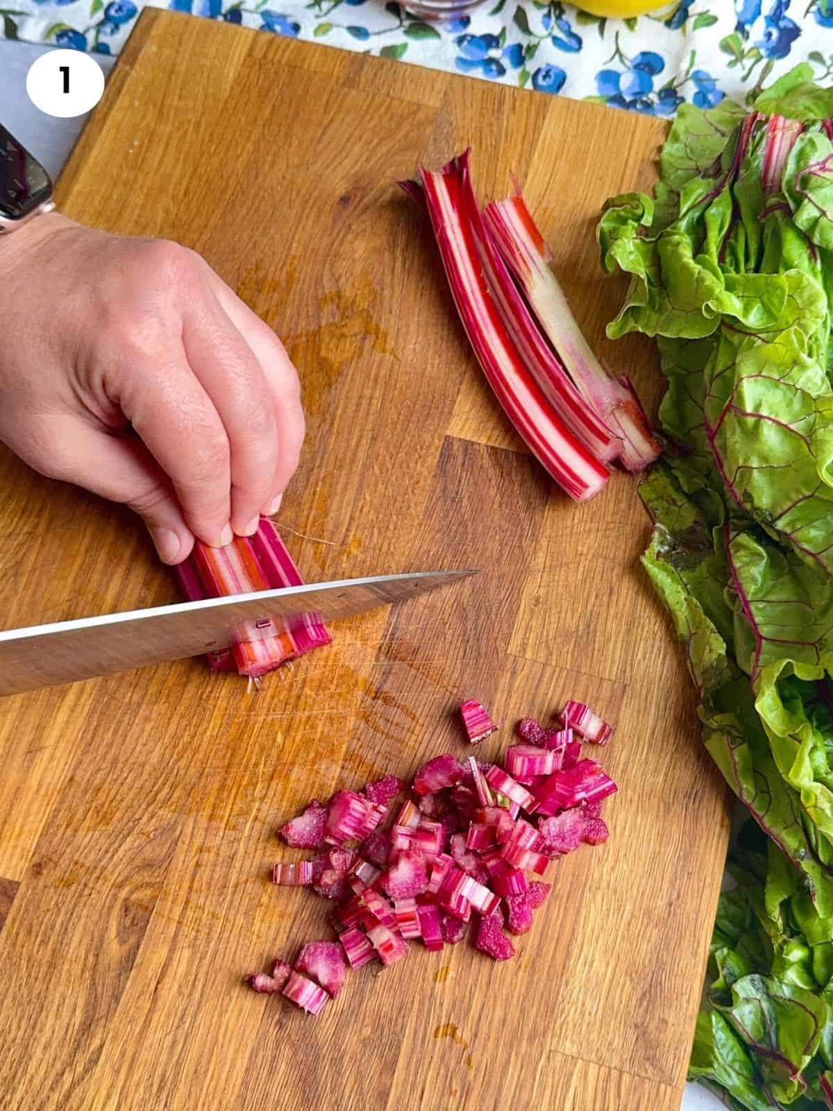 Cutting the swiss chard stalks into smaller bits.