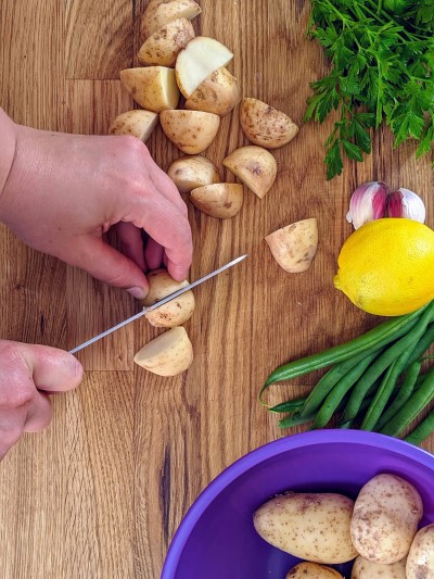 Cutting potatoes into quarters.