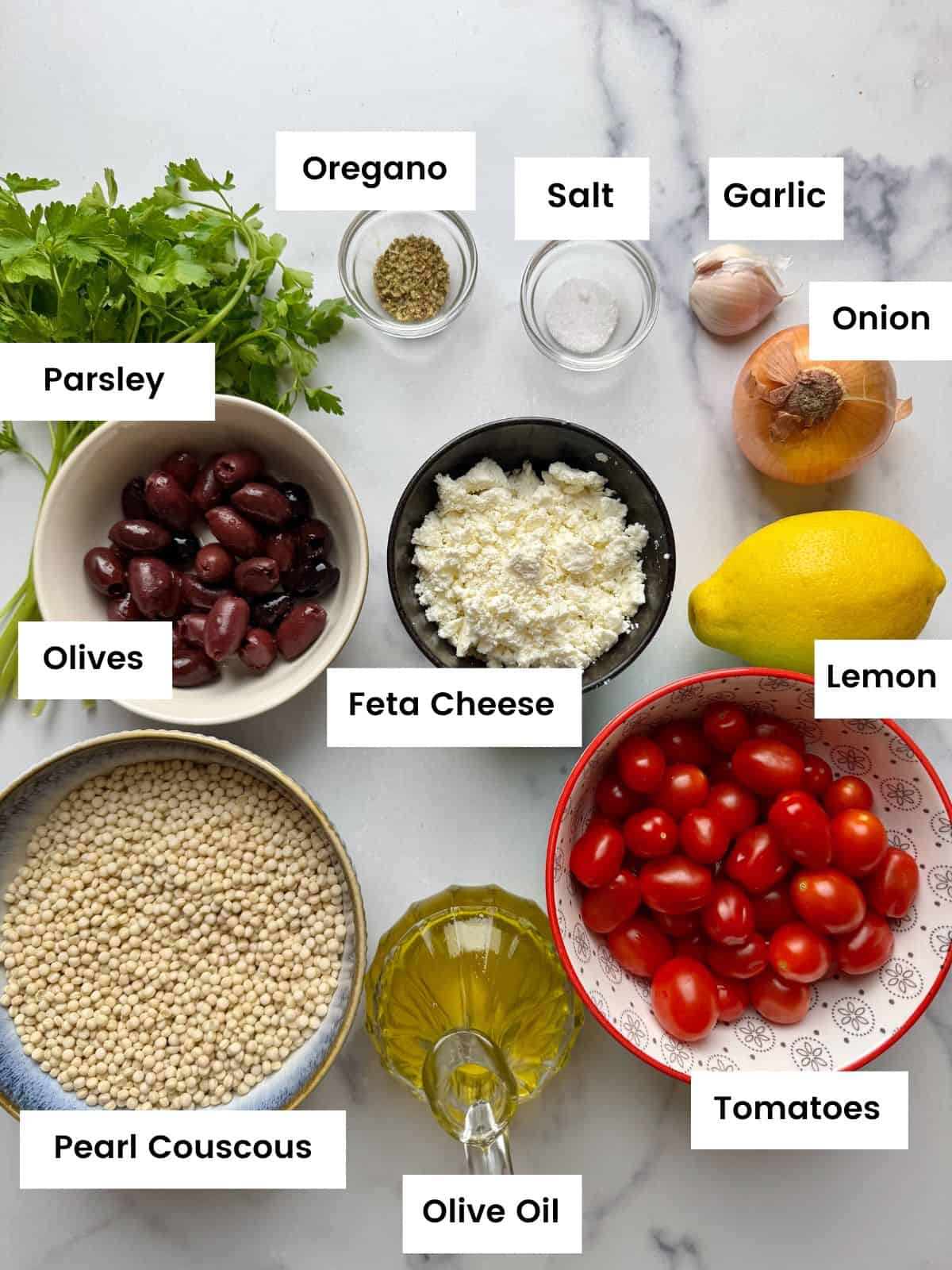 Ingredients for pearl couscous salad with roasted tomatoes and olives.