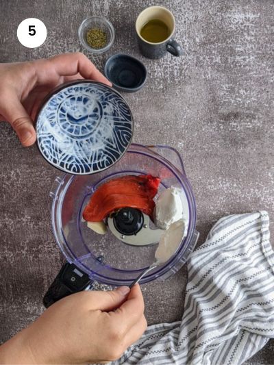 Adding the Greek yogurt to the food processor.