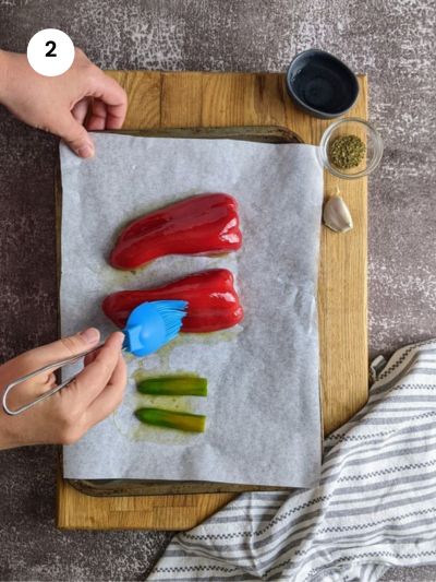 Brushing the peppers with oil.