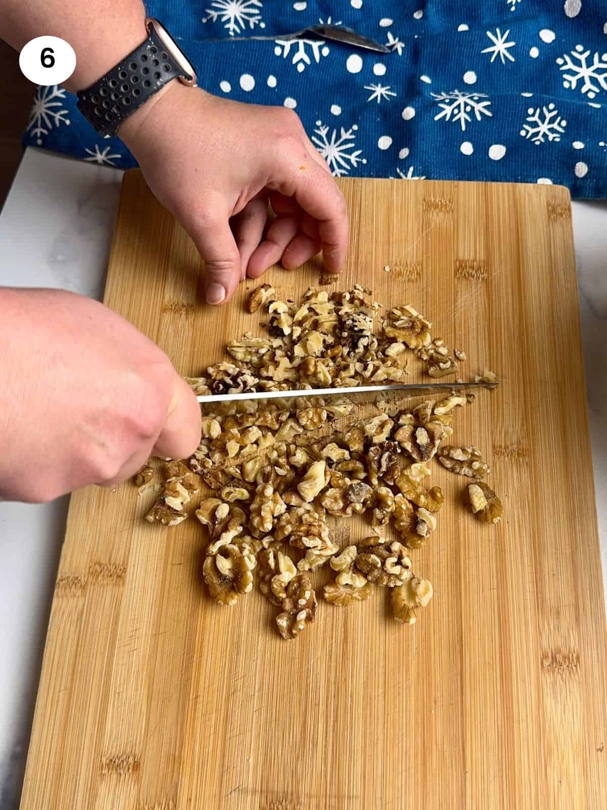 Chopping the walnuts with a knife.