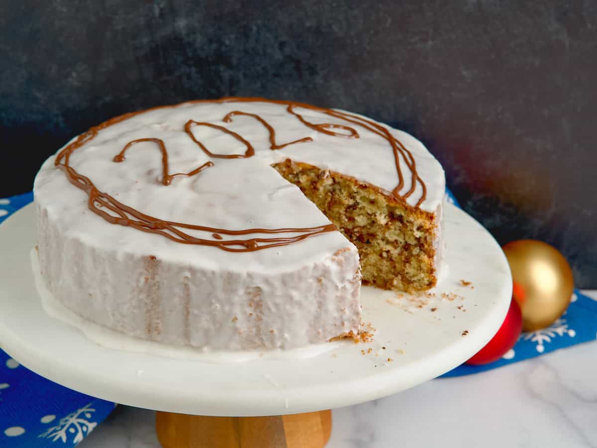 Vasilopita cake with one piece missing to see the inside of the cake.