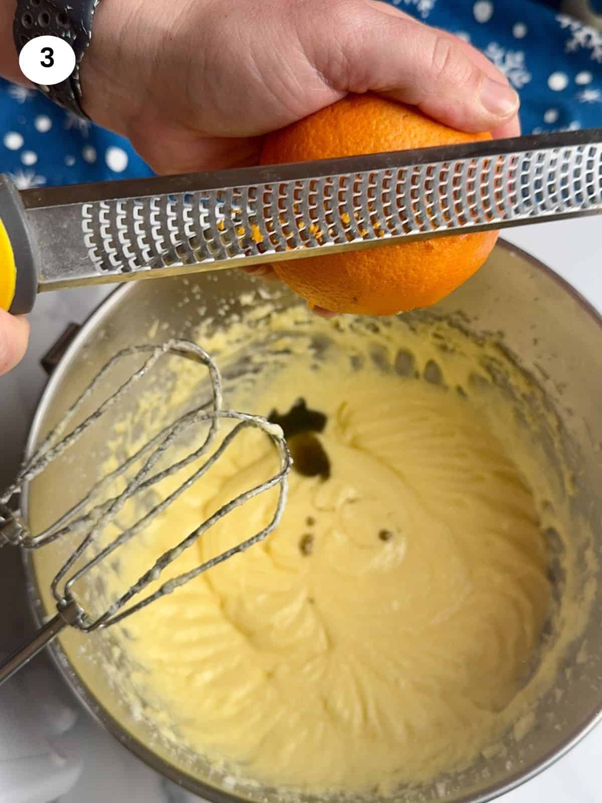 Adding the orange zest to the bowl.