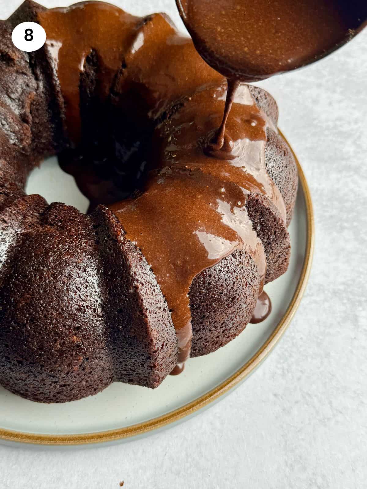 Pouring the chocolate glaze on the chocolate cake.