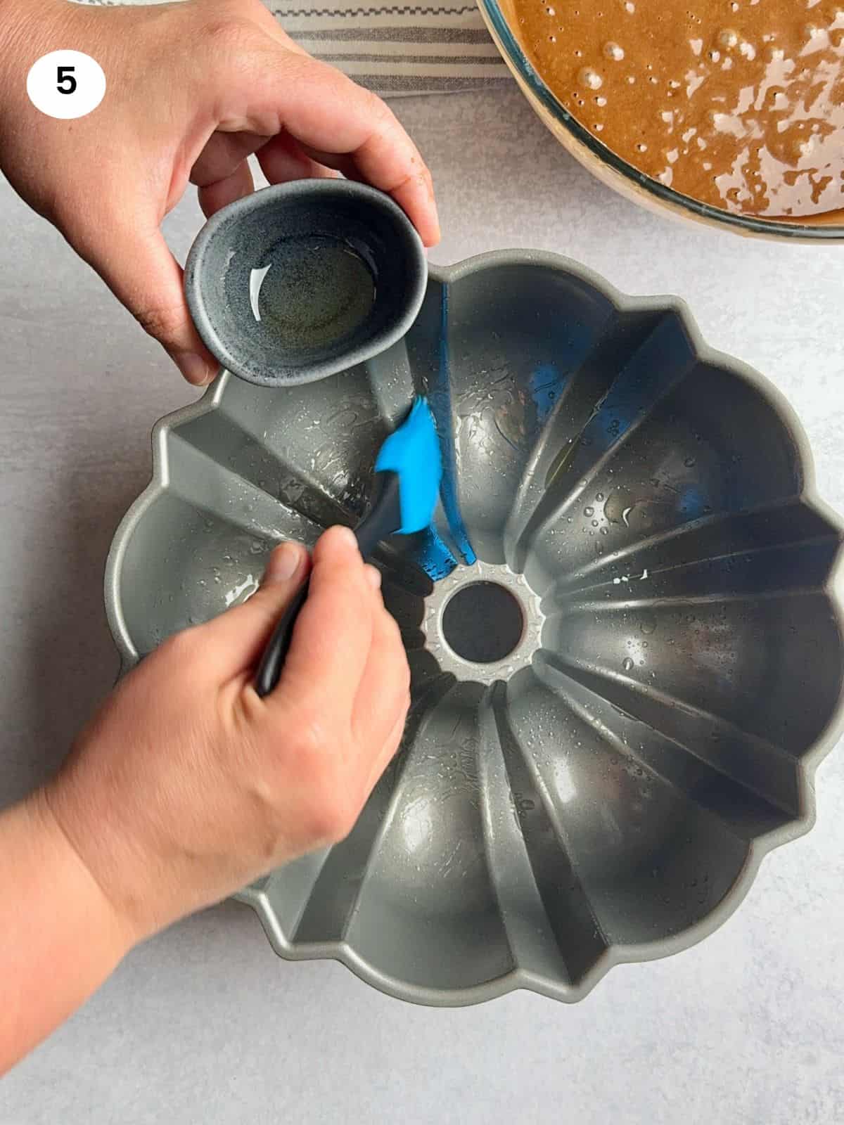 Oiling the bundt cake pan before adding the batter.