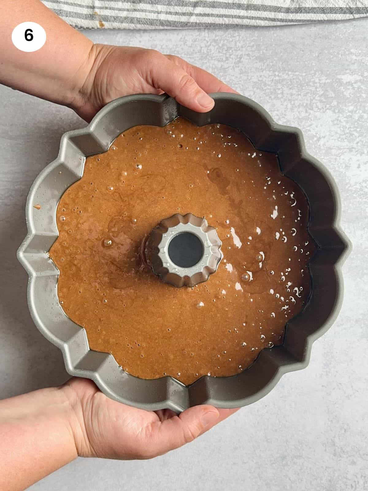 Chocolate batter in bundt cake pan ready to go in the oven for baking.