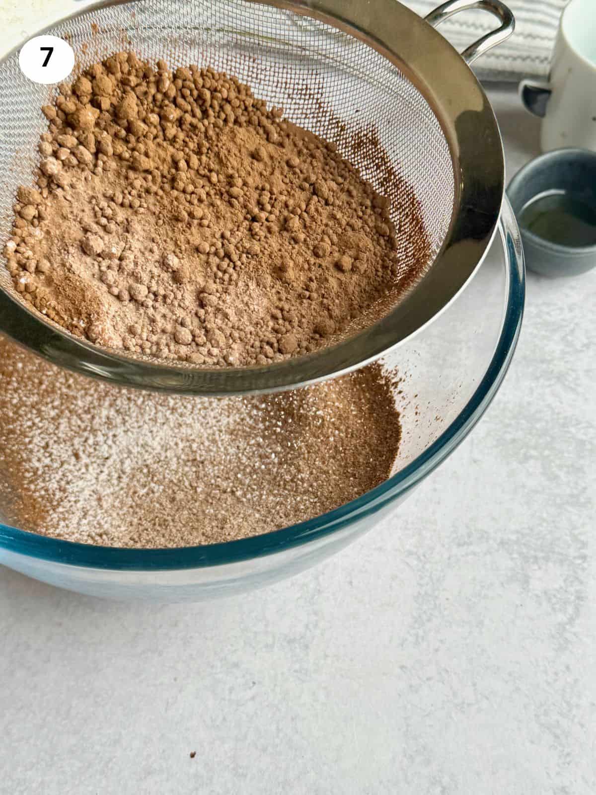 Sifting the powdered sugar and cacao for the glaze.