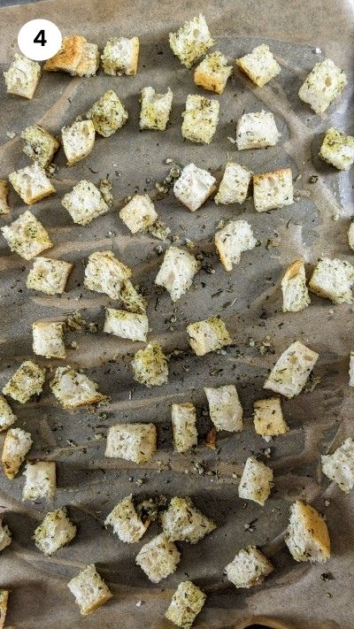 Adding the dressing on the bread cubes.