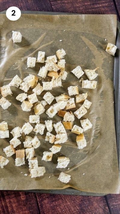 Adding bread cubes to the tray.