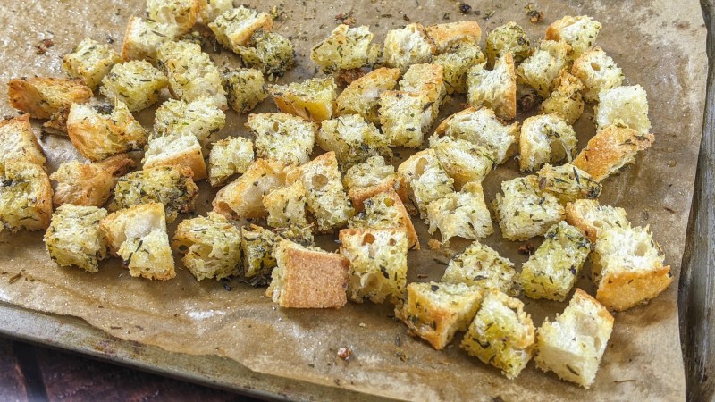 Vegan croutons with herbs out of the oven in the tray